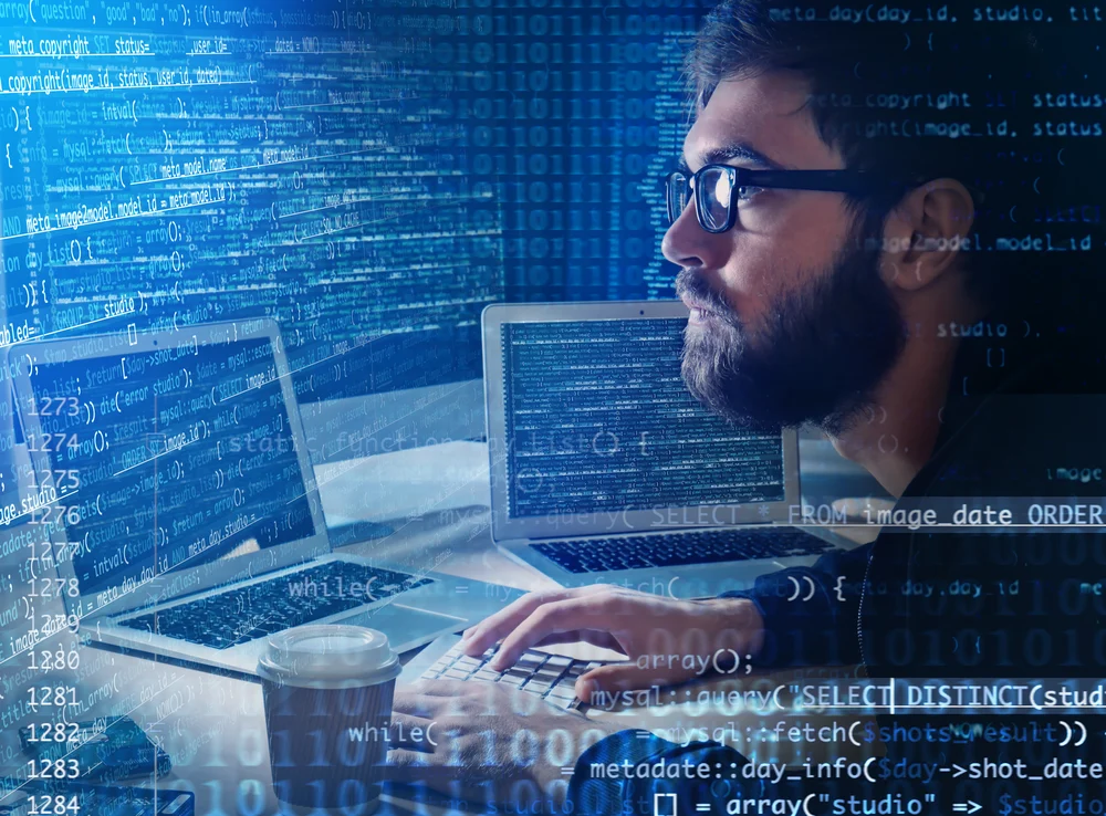 Hacker using computer in darkness. Concept of cyber attack and security