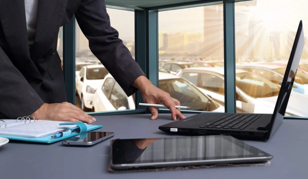 Car salesman working on computer